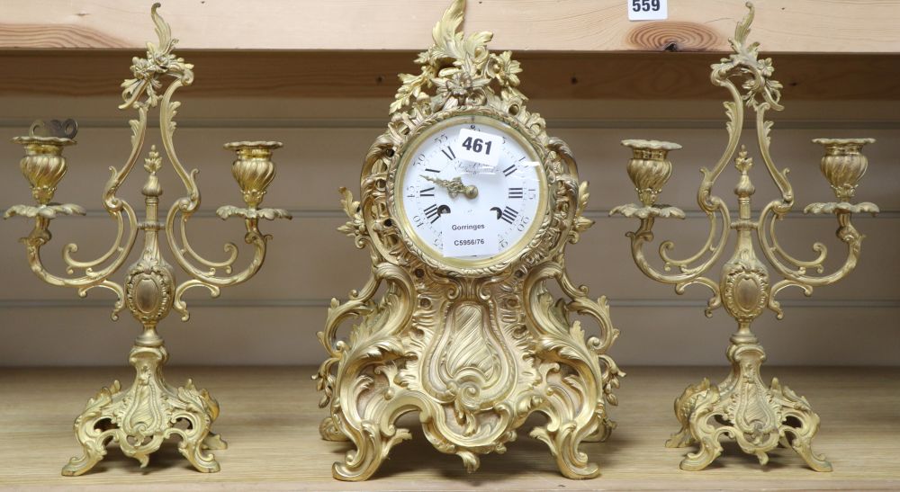 A Louis XV design cast ormolu rococo eight day mantel clock, with matching two branch candelabra, by Aug Le Roy, height 37cm